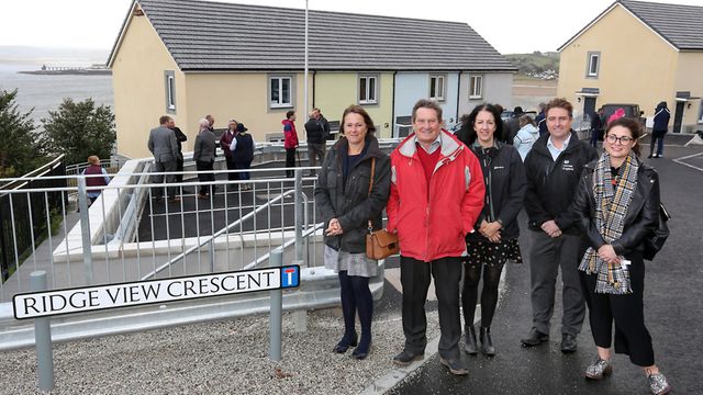 people outside the opening of community owned housing